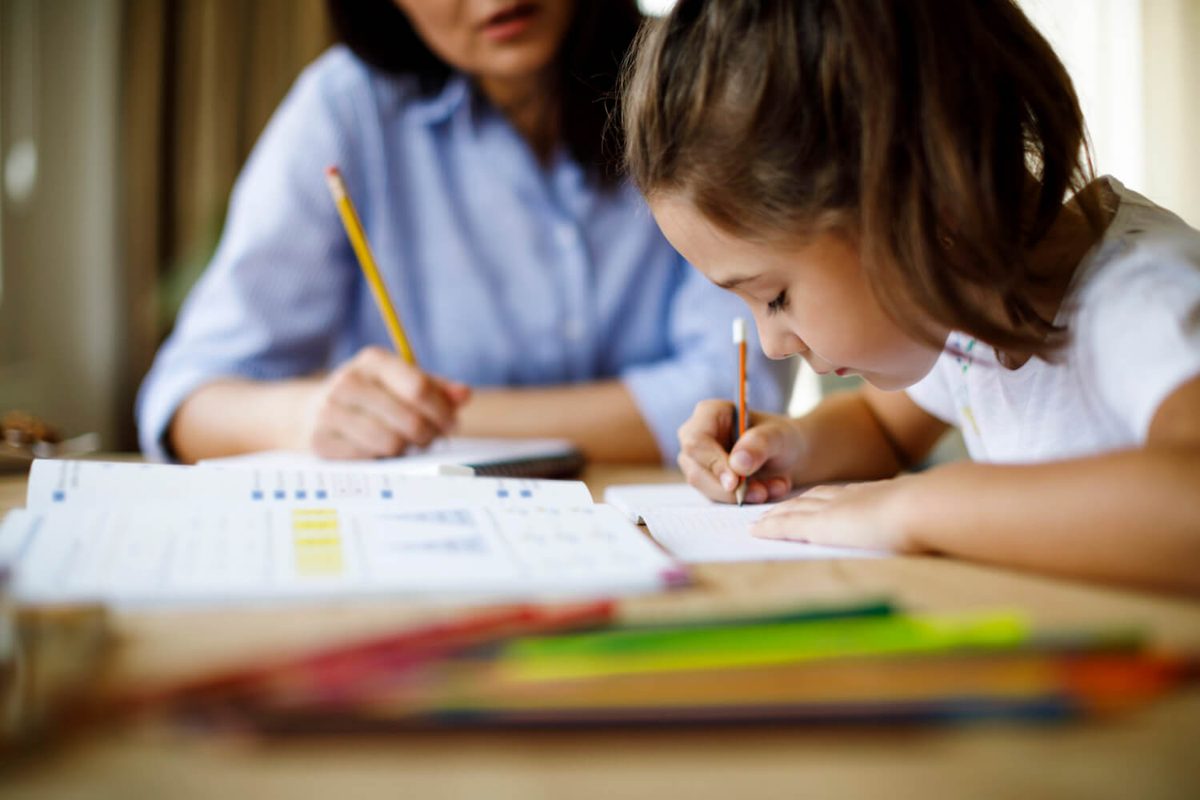 Tutor and pupil writing together
